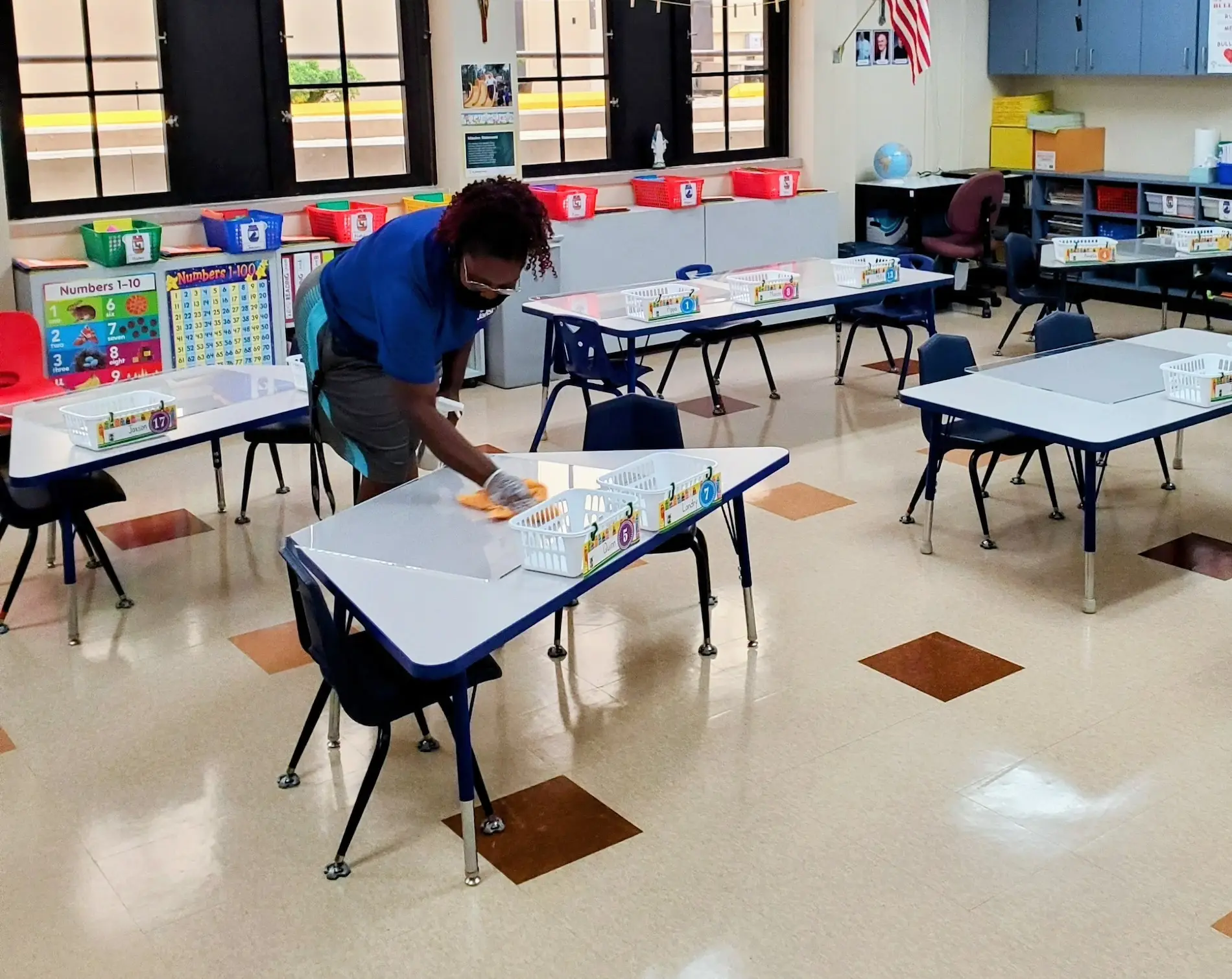 "Janitor cleaning tables" " janitor cleaning a classroom"