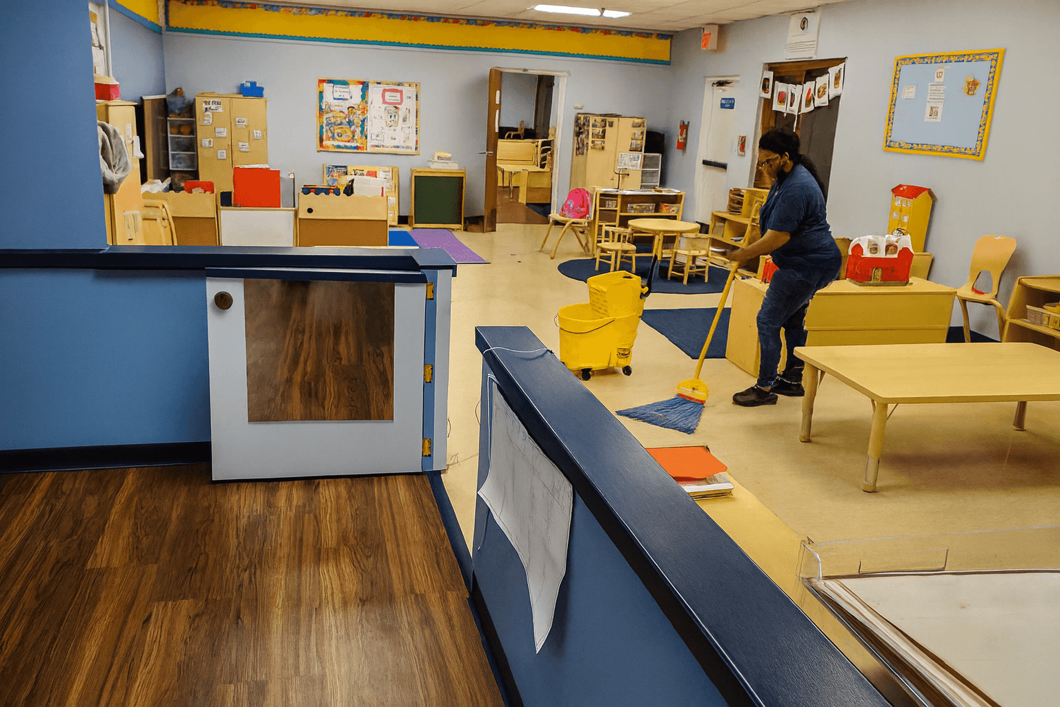 professional cleaning service janitor mopping school floor